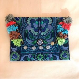Boho chic embroidered clutch with pompoms